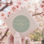 Sage Green Gold Heart Wedding Thank You Classic Round Sticker<br><div class="desc">Thank your guests in style with this elegant round wedding sticker featuring a soft sage green background, romantic gold rope heart, and personalized names and date. Ideal for sealing favor boxes, envelopes, or gift bags, this design complements rustic, minimalist, spring, or botanical-themed weddings. Fully customizable and perfect for couples who...</div>