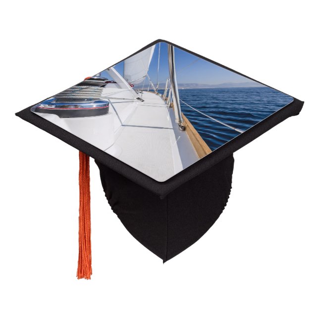sail vessel surfing on the sea graduation cap topper (Angled)