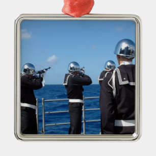 Sailors fire a gun salute during a burial-at-se metal ornament