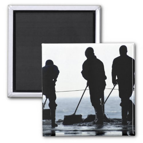 Sailors sweep out the hangar bay magnet