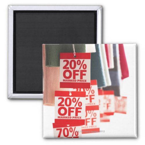 Sale tags attached to hanging clothes close_up magnet