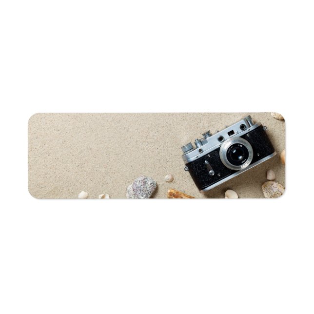 Sand Background. Concept With Old Retro Camera Label (Front)