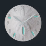 Sand dollar ocean beach white turquoise  round clock<br><div class="desc">A beach sand dollar in white and turquoise.  Perfect for a beach themed home decor. Numbers are optional.</div>