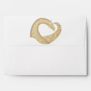 Sandstone heart dragon on white envelope