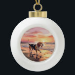 Sandy Paws Beagle Dog on Beach Sunset  Ceramic Ball Christmas Ornament<br><div class="desc">Immerse yourself in the tranquil beauty of our "Sandy Paws and Sunset Hues" dog on beach sunset design. This captivating scene captures the essence of a perfect evening at the shore, with a loyal canine companion enjoying the golden sands and the breathtaking hues of the setting sun. Whether you're a...</div>