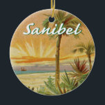 Sanibel Island Florida vintage beach Ceramic Ornament<br><div class="desc">Sanibel Island,  Florida commemorated with a vintage art beach sunset scene with palm trees and a boat. The name Sanibel is in a script font at the top.</div>