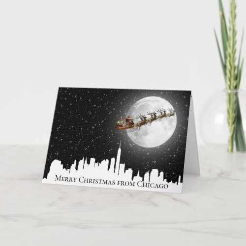 Santa and Sleigh Flying Over Big City Skyline Card