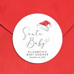 Santa Baby Christmas Baby Shower Classic Round Sticker<br><div class="desc">Cute stickers for your Christmas holiday season baby shower correspondence and party favors with "Santa Baby" in an elegant script with a heart swash and a watercolor illustration of a red Santa Claus hat. Personalize with the mother's name and shower date in simple modern typography.</div>