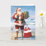 Santa By The Sea Christmas Card<br><div class="desc">A vibrant, tropical beach scene with a clear blue sky overhead. The golden sands stretch out as far as the eye can see, merging with the crystal-clear waters of the ocean. In the foreground, Santa Claus is depicted in his traditional attire. Santa is barefoot and has rolled up his pants...</div>