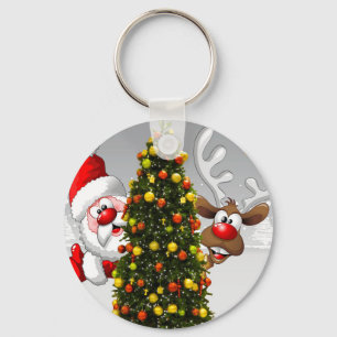 Santa claus and reindeer behind a christmas tree.j keychain