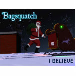 Santa Claus - Bagsquatch Cutout<br><div class="desc">Do you believe in Santa Claus? An image of Santa Claus along the lines of the striding Sasquatch from the Patterson-Gimlin film. Text reading "Bagsquatch" also appears along with customizable text reading "I BELIEVE." Bagsquatch, aka Bigbag, is an elusive, nocturnal figure generally only seen on one night in late December....</div>