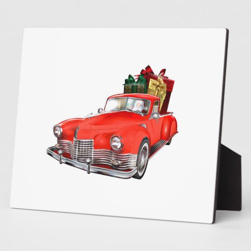 Santa Claus driving a retro car with giftsb Plaque