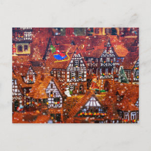 Santa Claus Flying Over a Gingerbread Village Postcard
