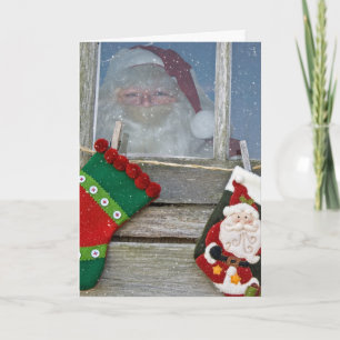 Santa Claus in cabin window with snowflakes Card