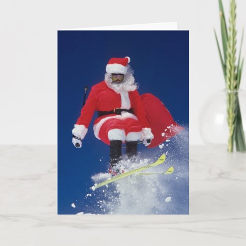 Santa Claus on skis jumping off a cornice at Holiday Card