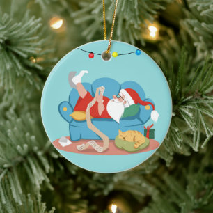 Santa Claus on the couch in pajamas Ceramic Ornament