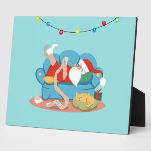 Santa Claus on the couch in pajamas Plaque
