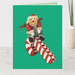 Santa Claus plays on candy cane slide for fun. Card
