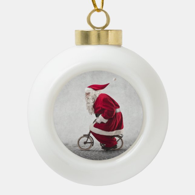 Santa Claus Rides A Bicycle Ceramic Ball Christmas Ornament (Front)