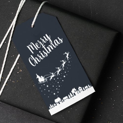 Santa Claus w sleigh  reindeers above the houses Gift Tags