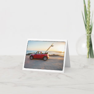 Santa driving Mini at the beach with a SUP Holiday Card