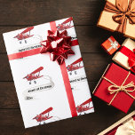 Santa Flying Airplane,First Christmas Personalized Wrapping Paper<br><div class="desc">Design features Santa flying as a pilot in a red airplane with a name banner. Banner can be customized with your child's name,  first Christmas,  and year text. This would be perfect for that little aviator! 

Copyright Soar In Style Designs LLC.</div>