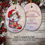 Santa Hat Kitten in Stocking Granddaughter Ceramic Ornament<br><div class="desc">Here's a beautiful keepsake ornament for that very special granddaugher. The front has an image of an adorable orange and white kitten peeking out of a patchwork Holiday stocking. The little kitten wears an oversized Santa hat, and holly sprigs surround him. The image is placed on a pale pink and...</div>