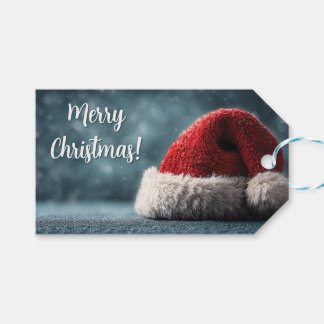 Santa Hat Resting on Snowy Surface with Greeting Gift Tags