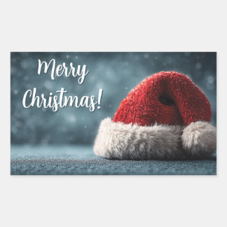 Santa Hat Resting on Snowy Surface with Greeting Rectangular Sticker