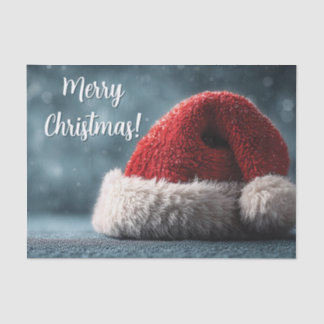 Santa Hat Resting on Snowy Surface with Greeting Tissue Paper