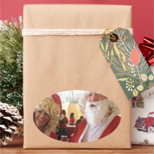 Santa & Mrs. Claus Christmas Celebration – Festive Oval Sticker