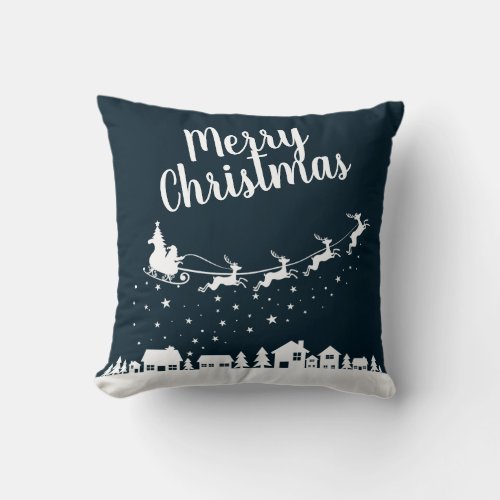 Santas sleigh  reindeers flying above the city throw pillow