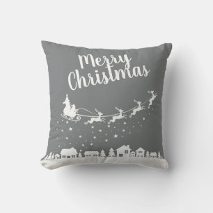 Santa's sleigh & reindeers flying above the city throw pillow