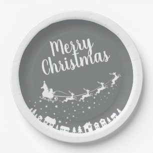 Santa's sleigh silhouette flying above the houses paper plates