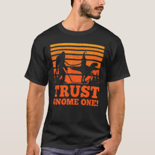 Sasquatch walking T-rex carrying a Gnome Trust Gno T-Shirt