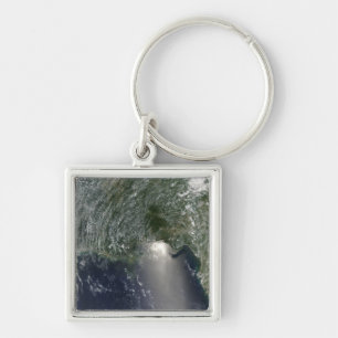 Satellite view of an oil spill keychain