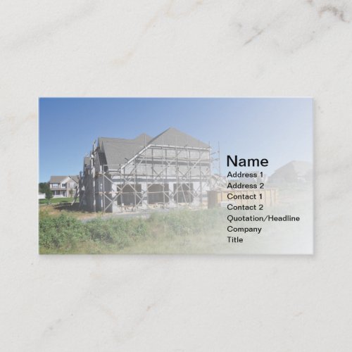 scaffolding by a large new home under construction business card