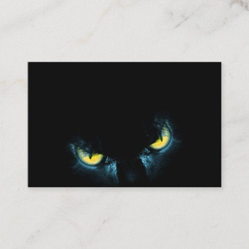 Scary cat eyes on a black background business card