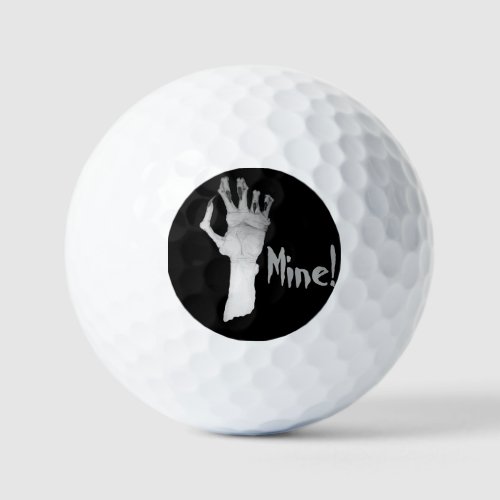 Scary gruesome gnarled monsters hand  golf balls