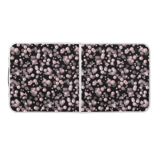 Scatterings of pink and white pearls on black velv beer pong table