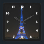 Scenic Eiffel Tower at Night Square Wall Clock<br><div class="desc">A scenic view from Paris,  France. The famous landmark,  the eiffel tower,  seen at night lit up by bright blue lights.</div>