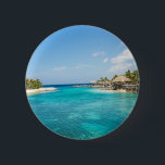 Scenic Tropical Beach with Thatched Huts Photo Button<br><div class="desc">A button with a beautiful photo featuring a tropical beach resort. 
Pretty blue water and white sandy beach with thatched huts giving it a tranquil island vibe.</div>