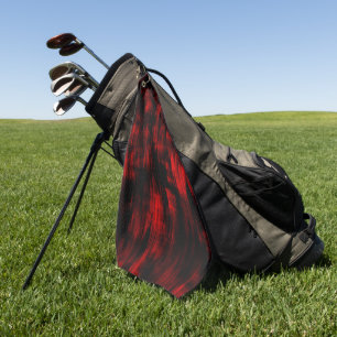 Scratched spots in bright red and black            golf towel