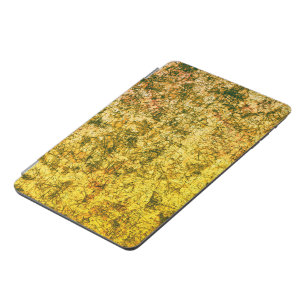 Scratches on a lightly spotted ocher yellow iPad mini cover