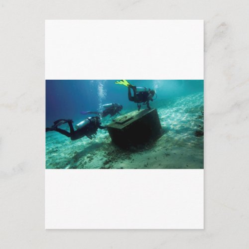 Scuba divers underwater with treasure chest postcard