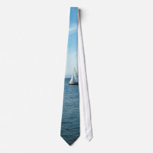 sea and sail boat under blue sky neck tie