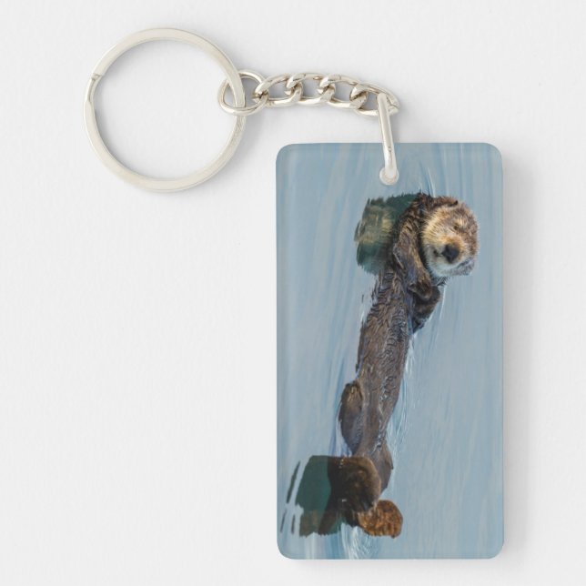 Sea otter floating on back in ocean keychain (Front)