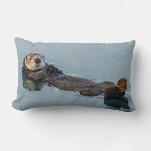 Sea otter floating on back in ocean lumbar pillow