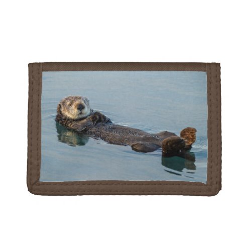 Sea otter floating on back in ocean tri_fold wallet