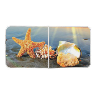 Sea shells and starfish on beach beer pong table